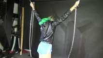 Watching sexy Sonja wearing a sexy lightblue shiny nylon shorts and a black shiny nylon rain jacket being tied and gagged overhead with cuffs, chains and a clothgag (Video)