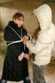 Blond-haired archive girl tied and gagged by another archive girl wearing shiny down jackets (Pics)