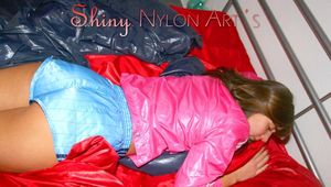 Alina preparing her bed for relaxing and lolling on the bed wearing sexy shiny nylon shorts and a rain jacket (Pics)