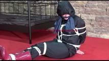 Jill tied, gagged and hooded lying on the floor wearing sexy shiny nylon black rainwear (Video)