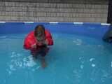 Watch Sandra enjoying the Pool during a hot summer Day with her shiny nylon Downjacket