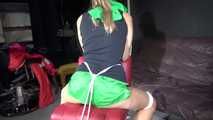 Watching sexy Sandra wearing a sexy green shiny nylon shorts and a black top being tied and gagged with ropes and a clothgag on a chair (Video)