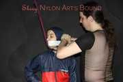Sexy Aiyana wearing a supersexy shiny nylon rainsuit being tied and gagged and hooded overhead with ropes (Pics)