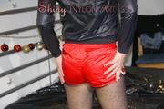 Watching Pia dressing herself with a red shiny nylon shorts over her nylons and a rain jacket (Pics)