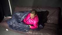 Watching sexy Sandra wearing a sexy pink shiny nlon rain pants and a shiny nylon pink down jacket nestle down in a down cover (Video)