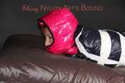Watching sexy Sandra wearing a sexy pink shiny nylon rain pants and a shiny nylon pink down jacket being tucked in a down cover and tie and gagged and hooded with tape and a ballgag (Pics)