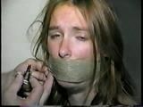 24 Yr OLD CRAFTER IS WRAP TAPE GAGGED, BAREFOOT TICKLED, TOE-TIED, BALL-TIED, HANDGAGGED & MOUTH STUFFED (D61-1)