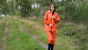 Miss Petra takes a walk in a orange AGU rain suit and rubber boots