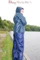 Sexy archive girl wearing a blue rain pant and rain jacket walking on a lake in freetime (Pics)