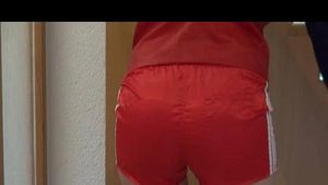 Sonja cleaning up the corridor wearing a very hot red shiny nylon shorts and an oldschool red/blue rain jacket (Video)