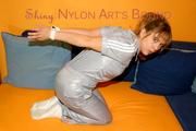 Beautiful archive girl tied and gagged wearing a shiny grey nylon jumpsuit(Pics)