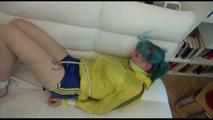 Mara tied and gagged on a white sofa in a reading lounge wearing a sexy blue/yellow shorts and a yellow rain jacket (Video)