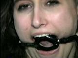 ERICA IS RING GAGGED, MOUTH STUFFED, CLEAVE GAGGED & TIED WITH BLACK NYLON ROPE (D36-10)