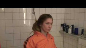Watching sexy Katharina wearing a sexy black shiny nylon shorts and an orange downjacket enjoying her foambath (video)