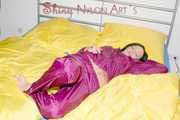 ENNI wearing a sexy purple shiny nylon rain suit lying in bed with yellow shiny nylon cloths lolling and posing (Pics)