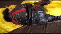 Lucy wearing a sexy black/red shiny nylon downsuit preparing her bed with nylon linen and enjoys it (Video)