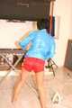 SEXY ENNI wearing a hot red shiny nylon shorts and a lightblue shiny nylon rain jacket during ironing the shirt of her boyfriend (Pics)