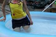 Sexy Sonja wearing a darkblue shiny nylon shorts and a yellow top enjoying the water in the swimming pool (Pics)